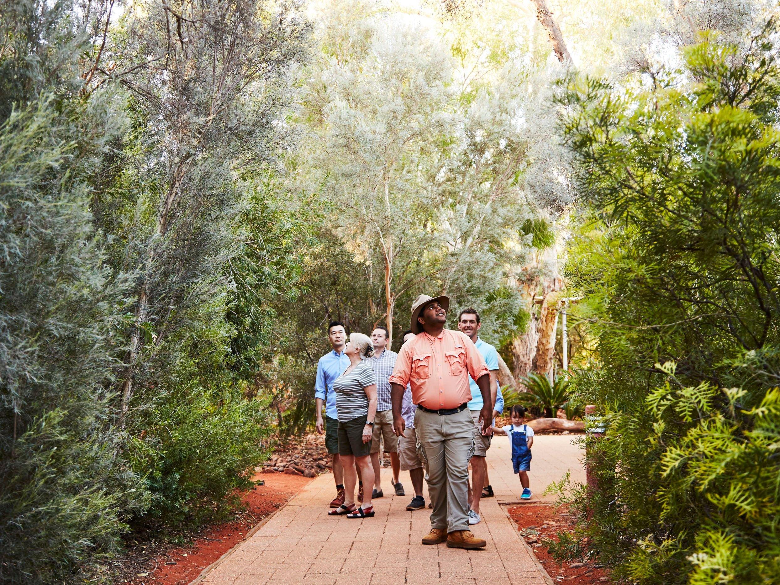 group with a tour guide on Garden walk at Ayers Rock Resort