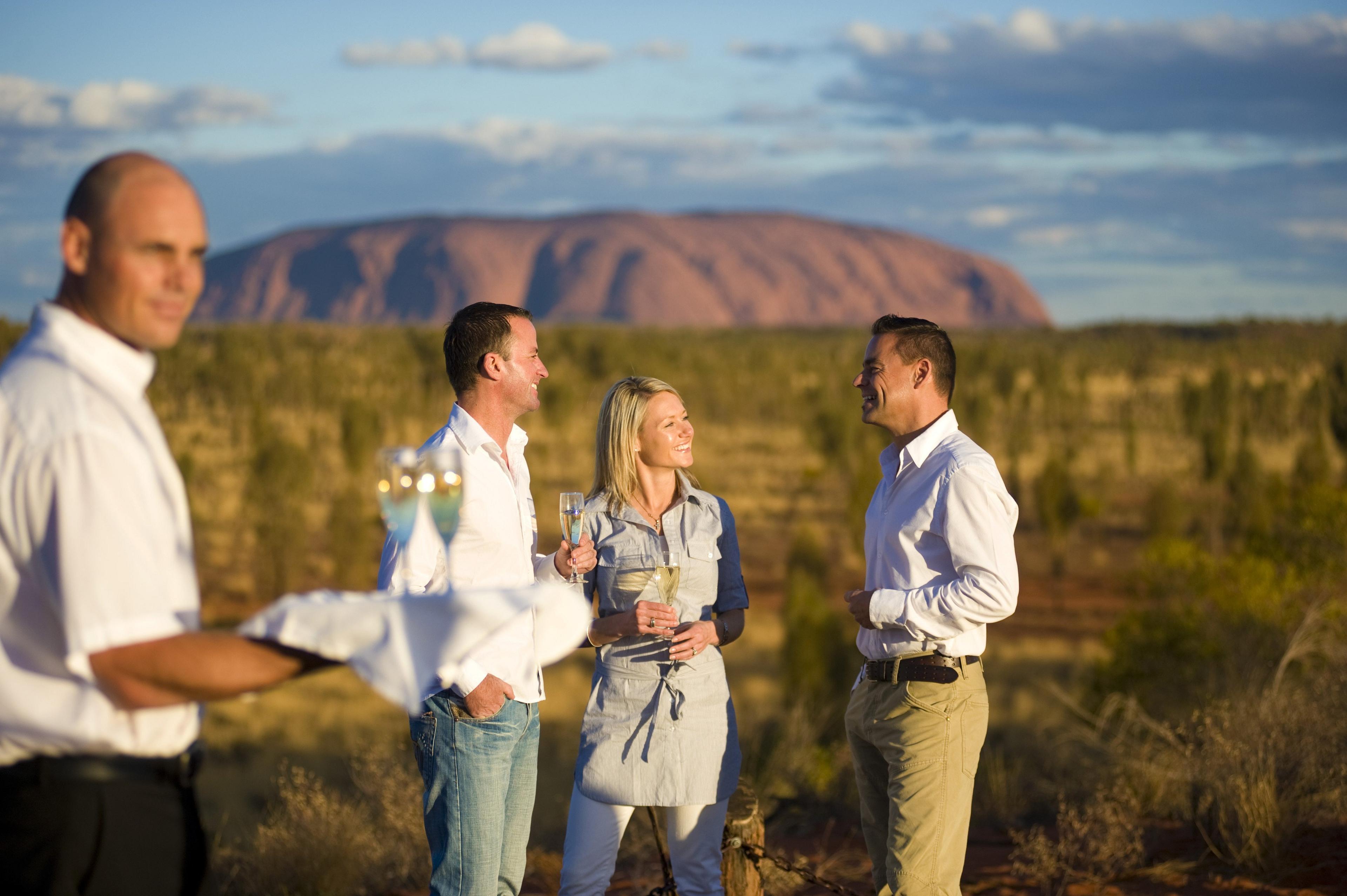 A couple enjoy date night with Uluru in the background