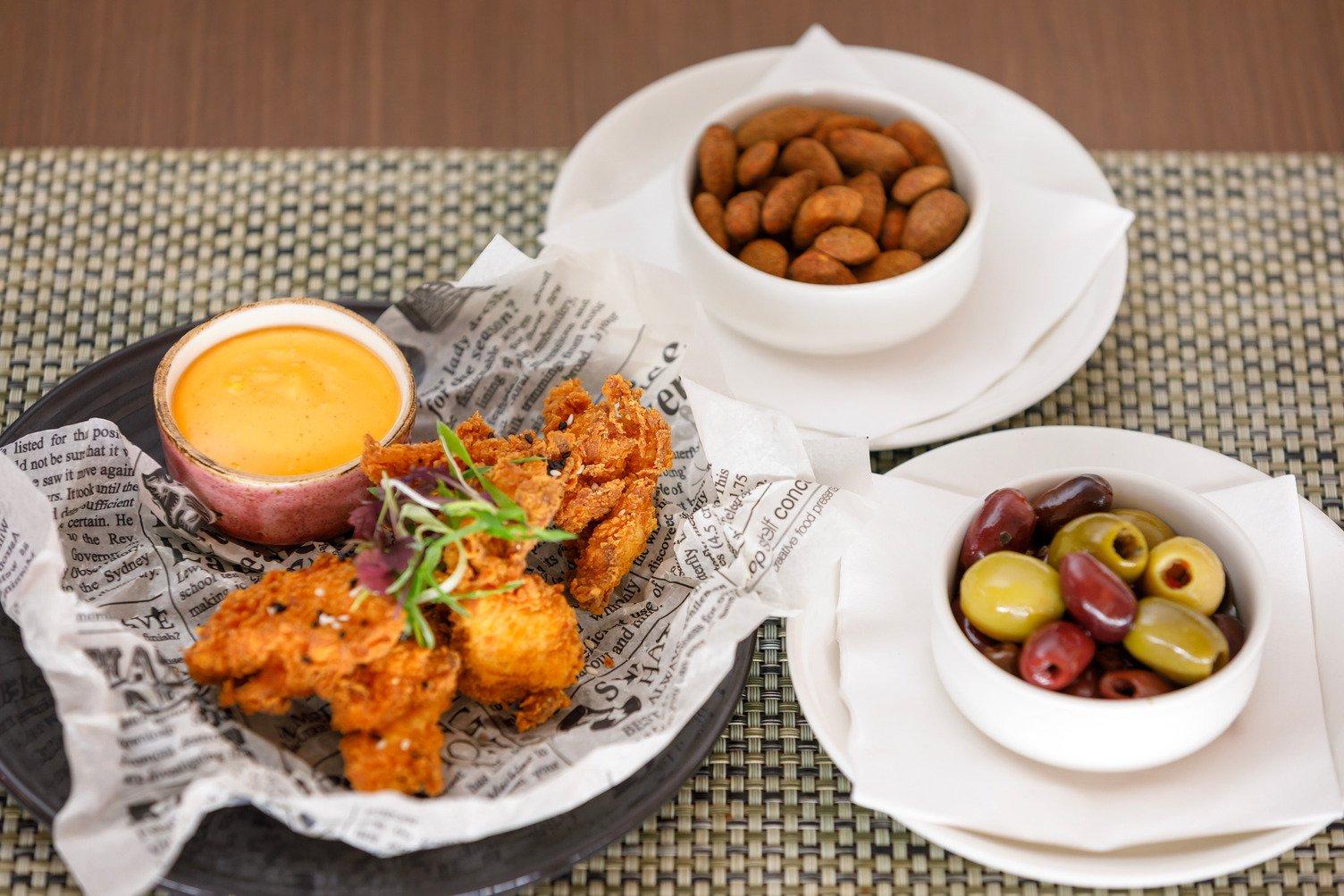 Bar snacks including chicken, olives and nuts served at Mangata Restaurant