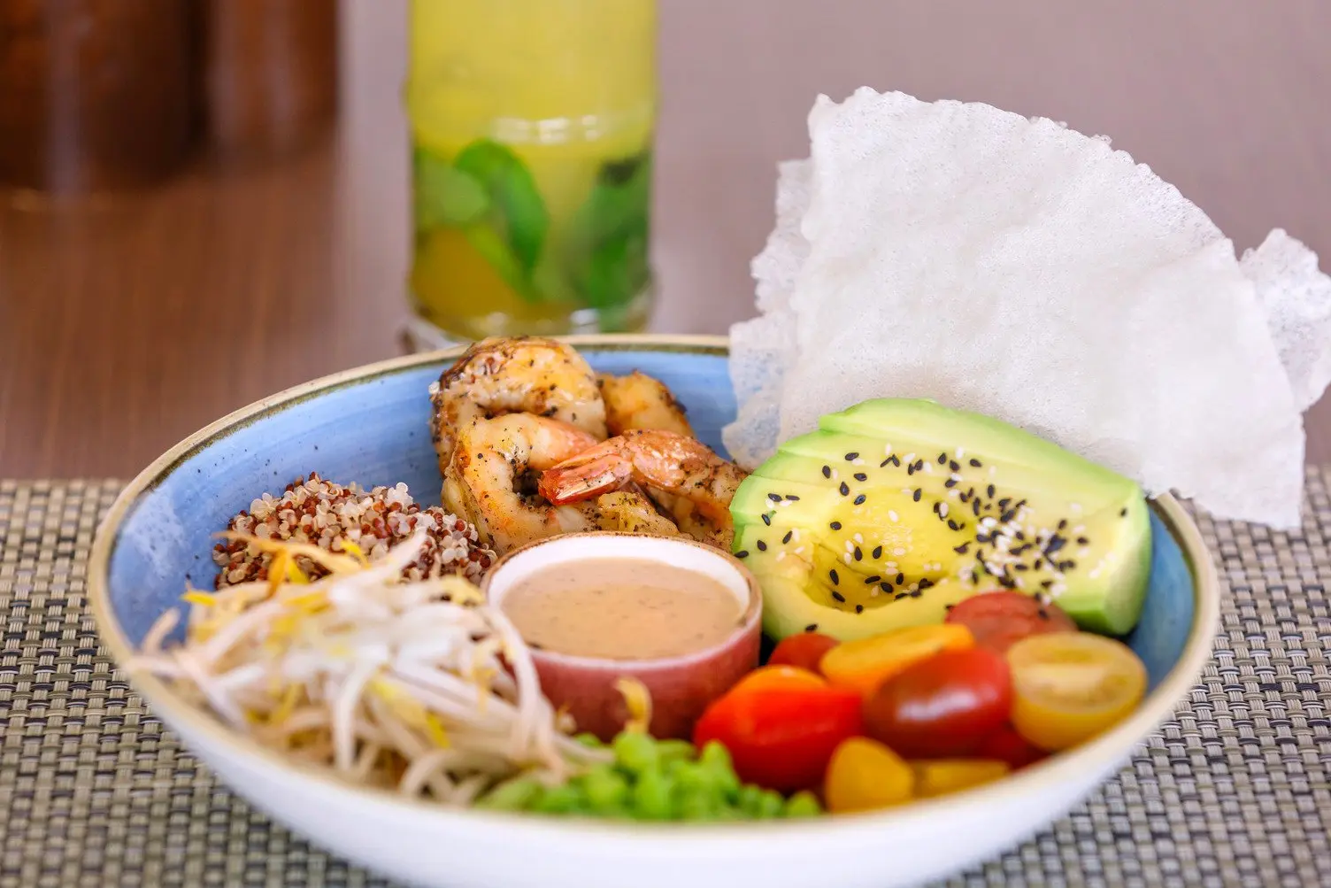 Poke Bowl with crumbed prawn, edamame, avocado and tomato served with a refreshing cocktail