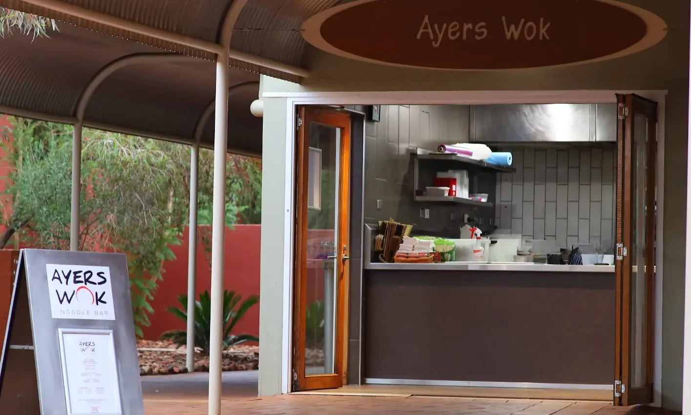 The entrance of Ayers Wok in Towns Square with signate displaying the menu and kitchen