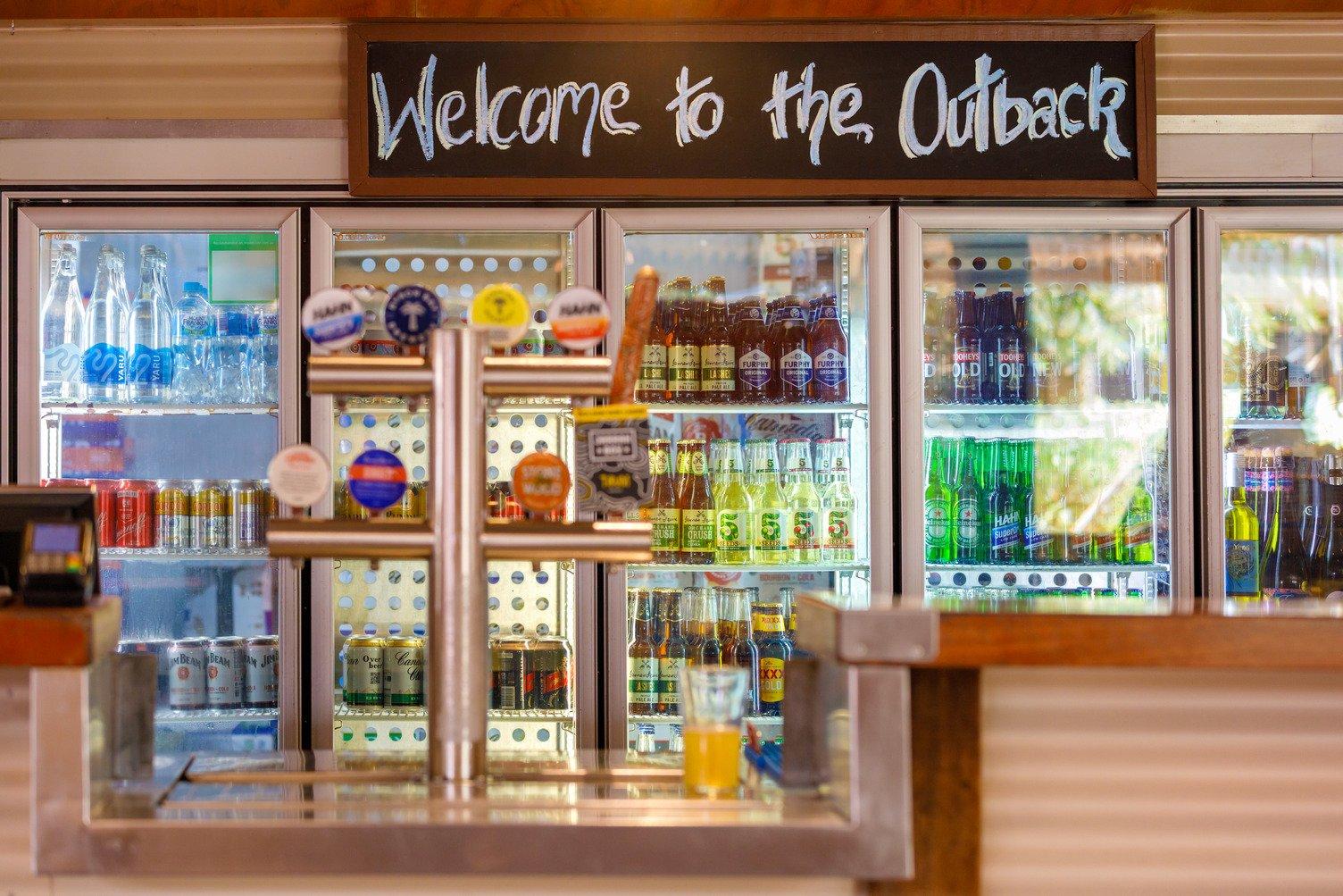 Beer and drinks on tap, and lcoholic bottle and can drinks in the fridge