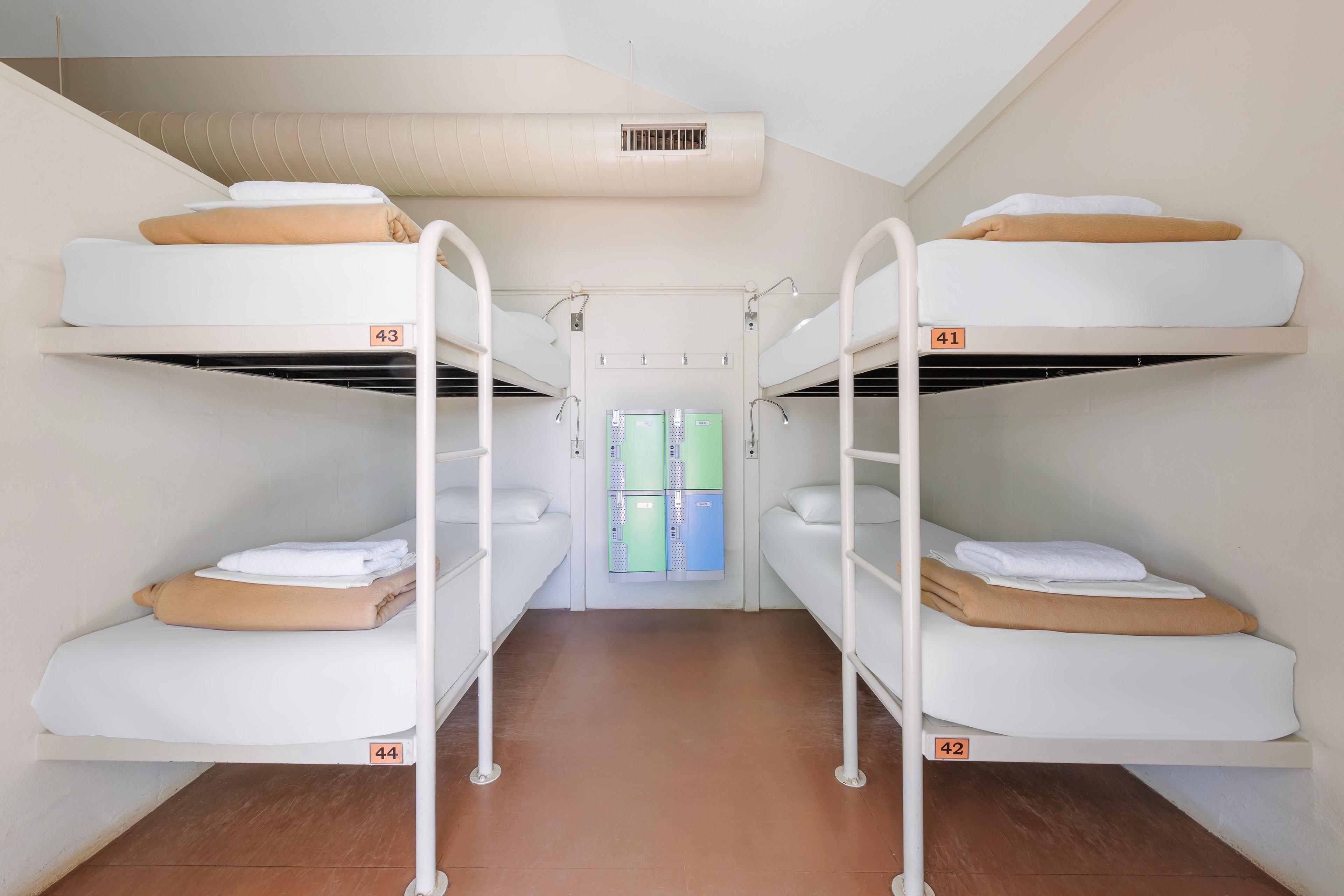 2 beds that sit within a 20 bed dormitory 