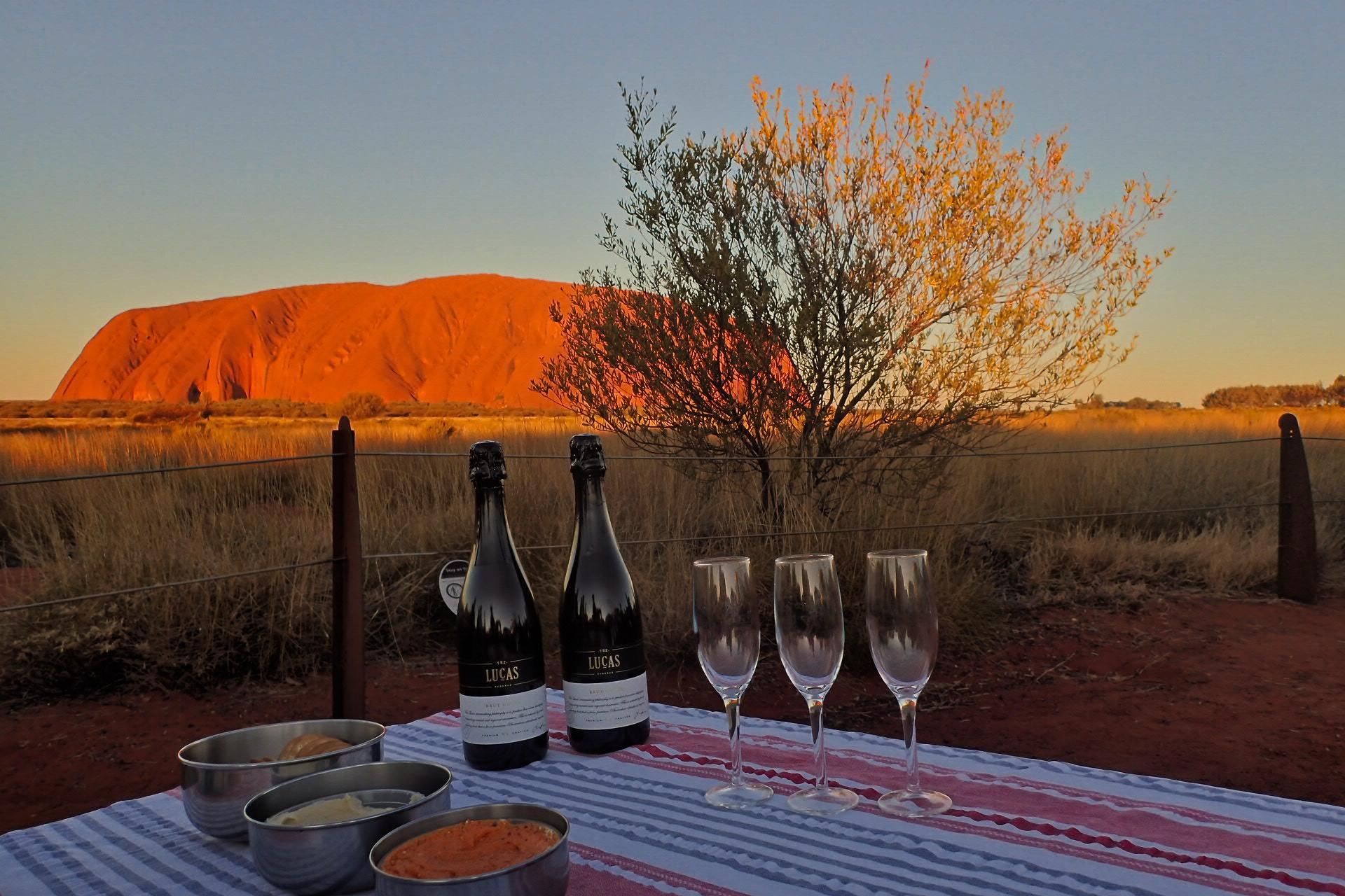 Uluru at sunset with sparkling wine and light refreshments
