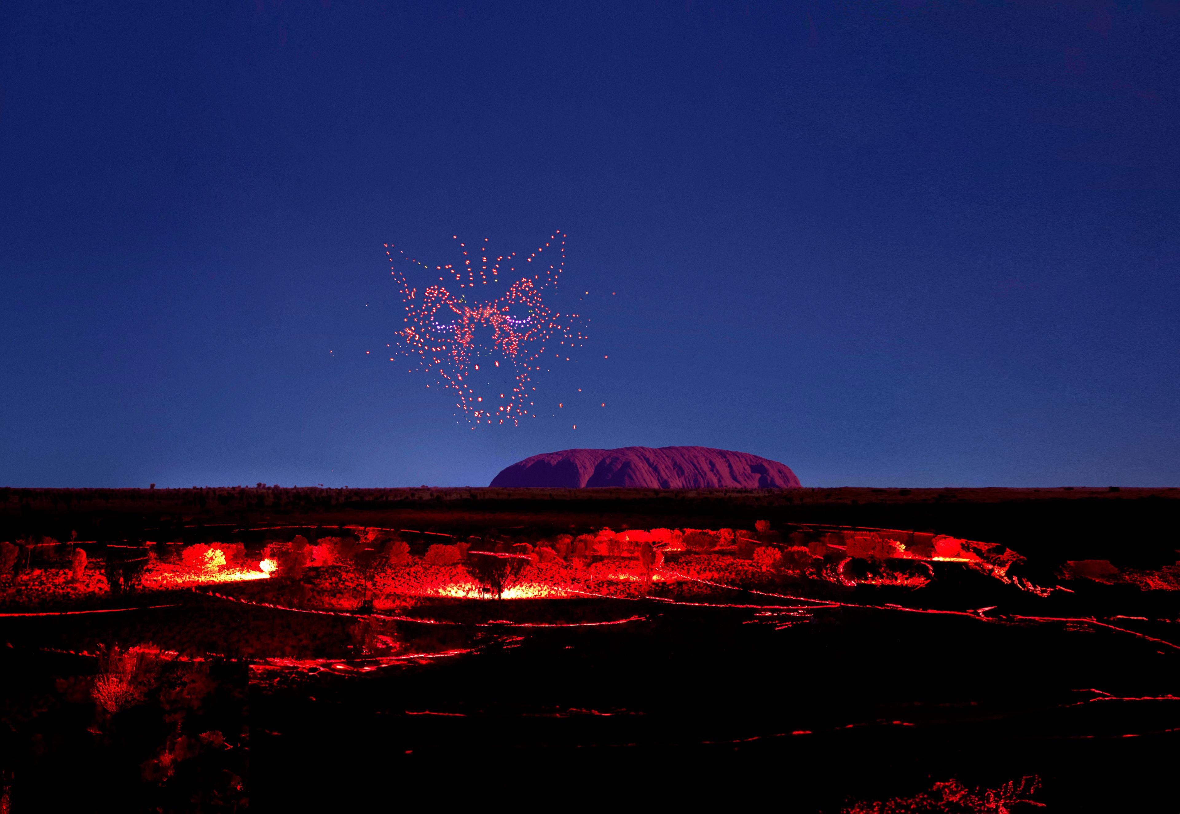 wintjiri wiru kurpany over the outback landscape in front of uluru