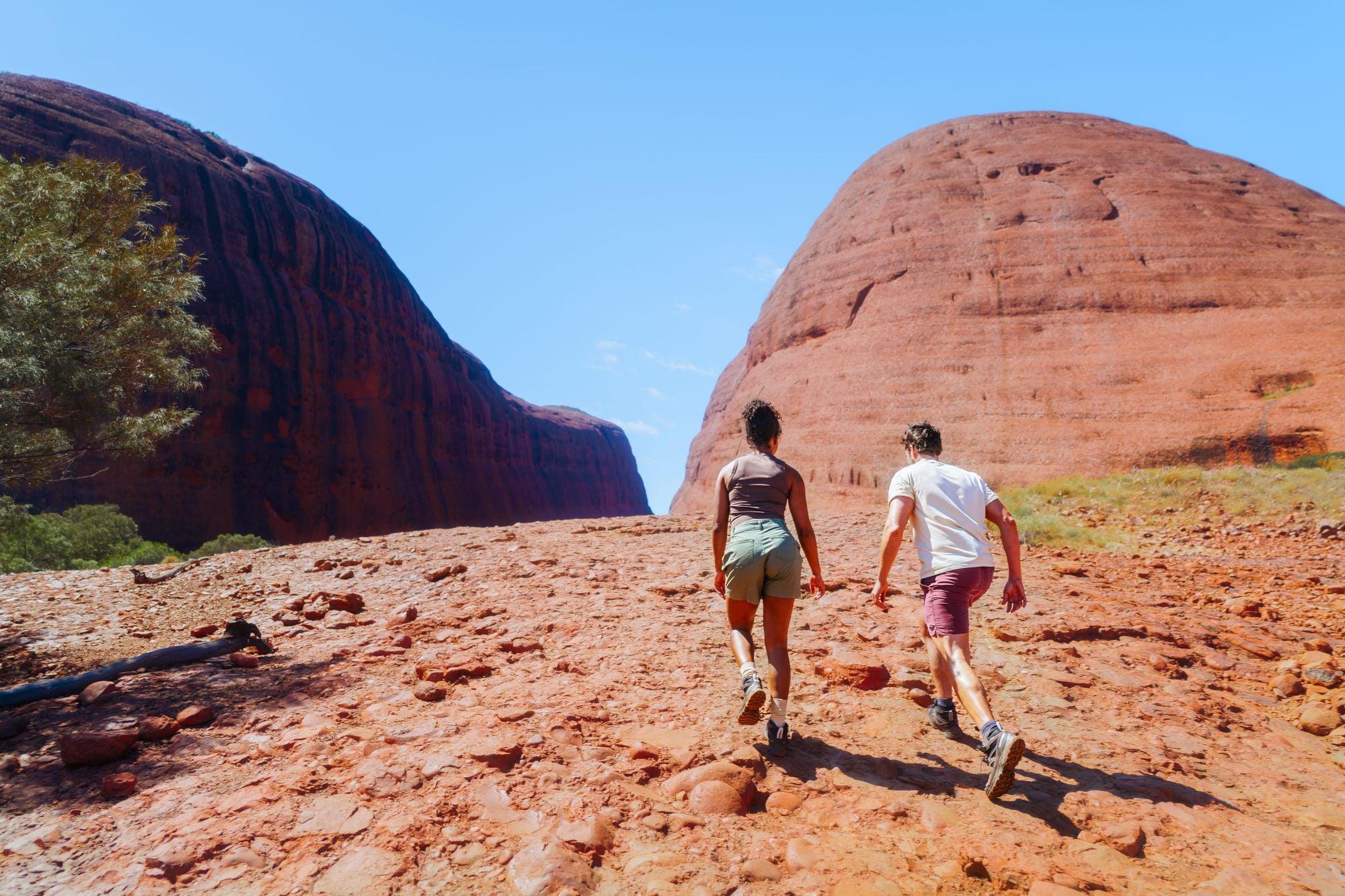 A young couple hiking at Kata Tjuta, in the Northern Territory of Australia