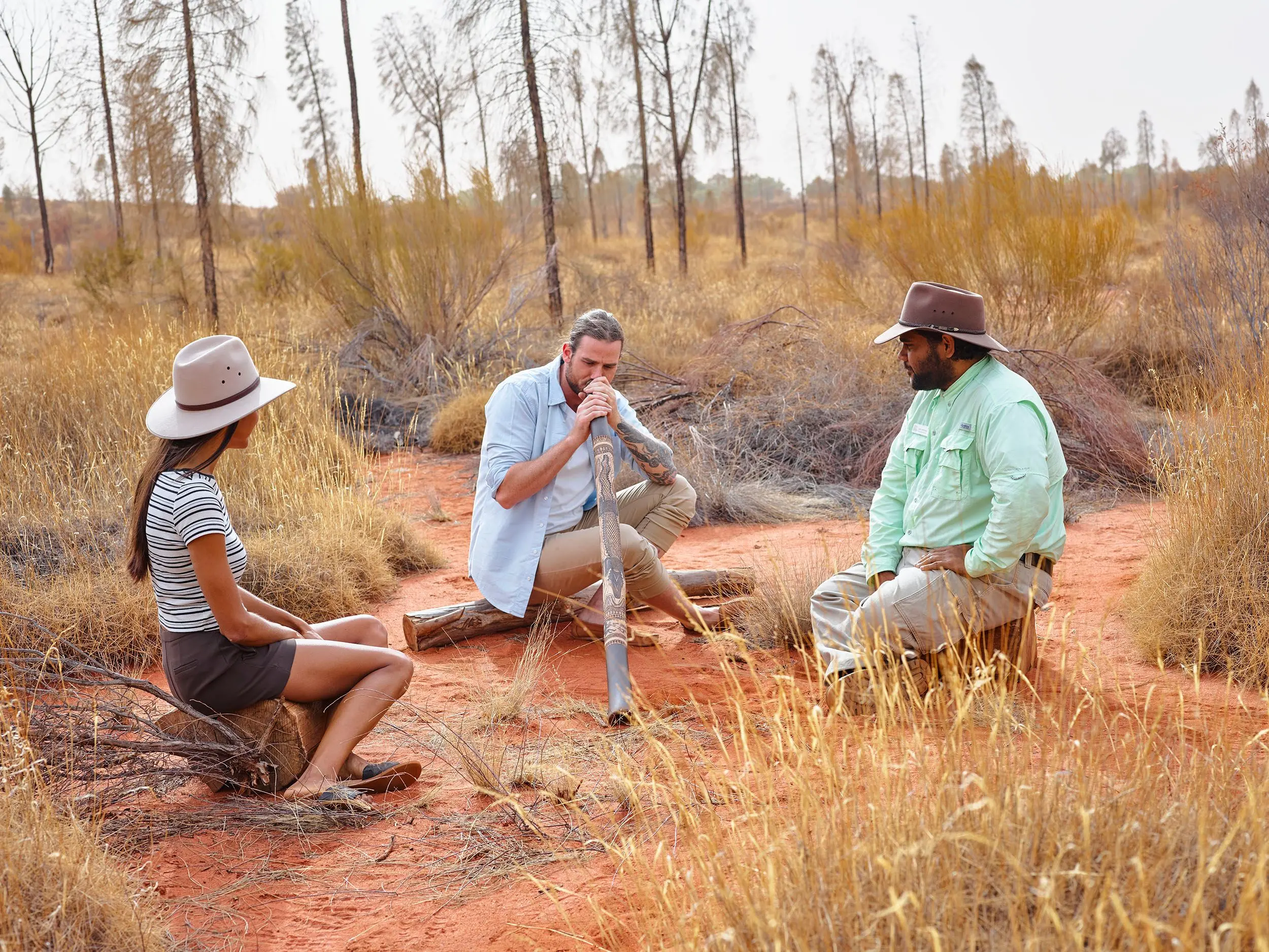 Man learning to play didgeridoo