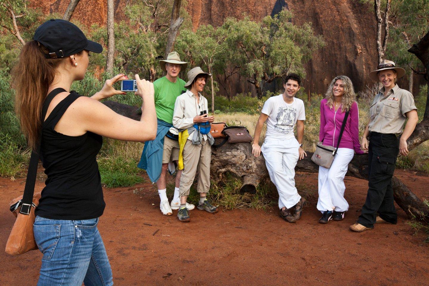 Group of tourist taking photos on the Uluru Trek