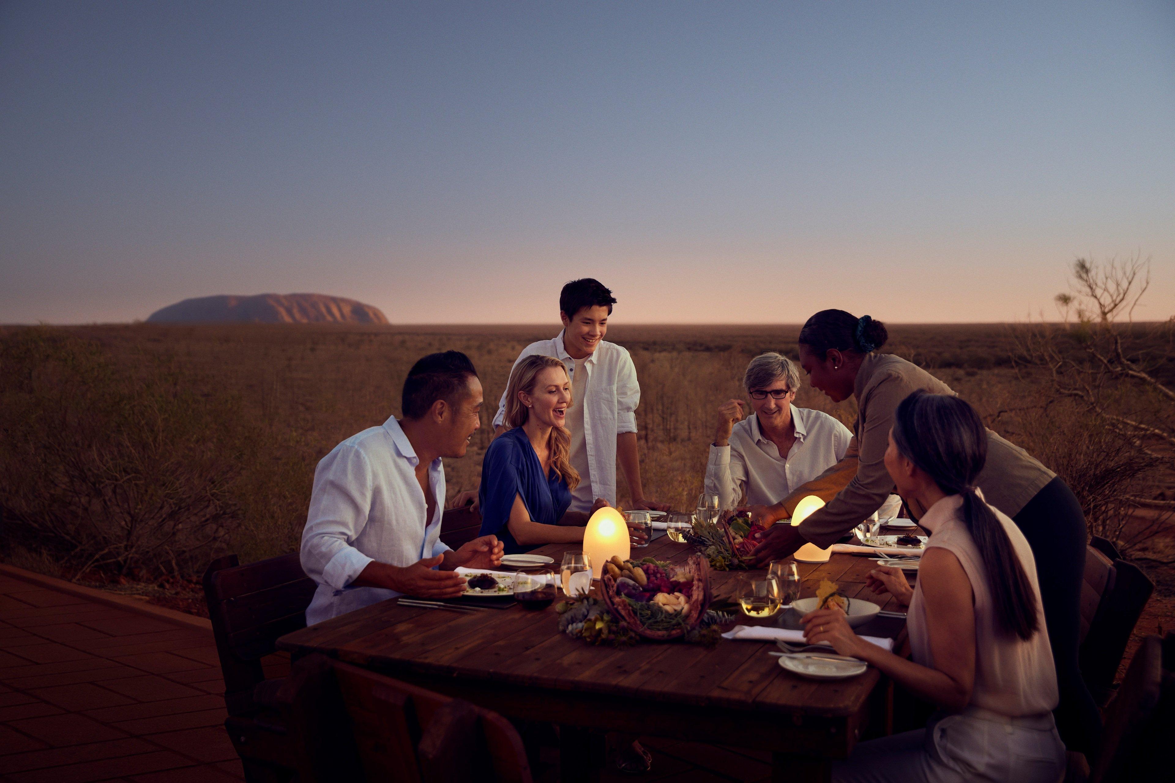 Friends enjoying dinner at Tali Wiru