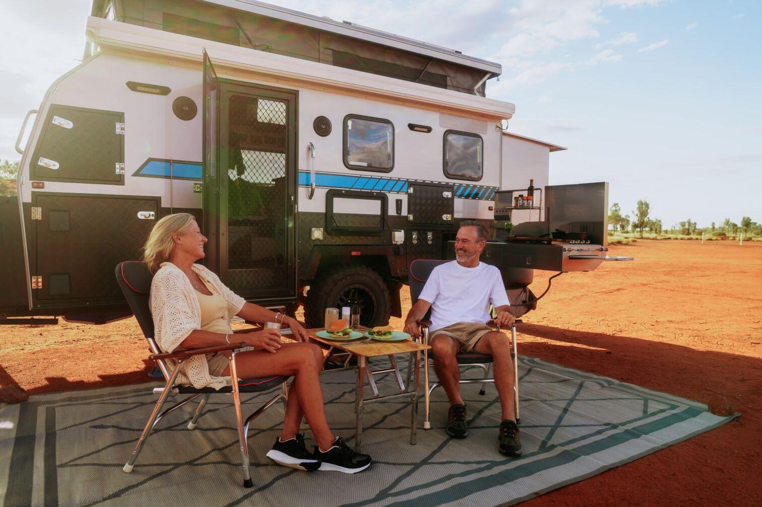 Two people and Caravan at Ayers Rock Campground