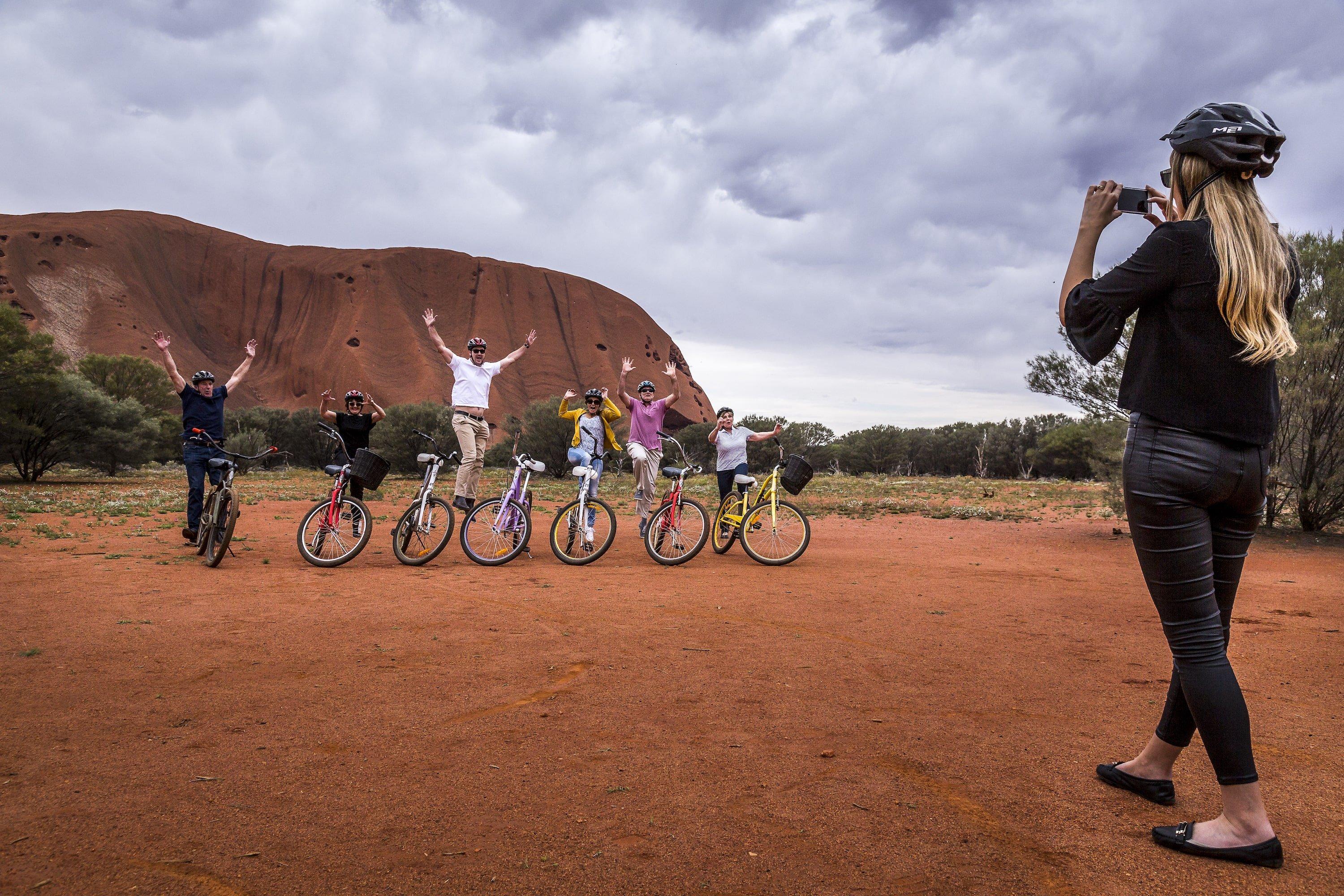 Group cycling around Uluru