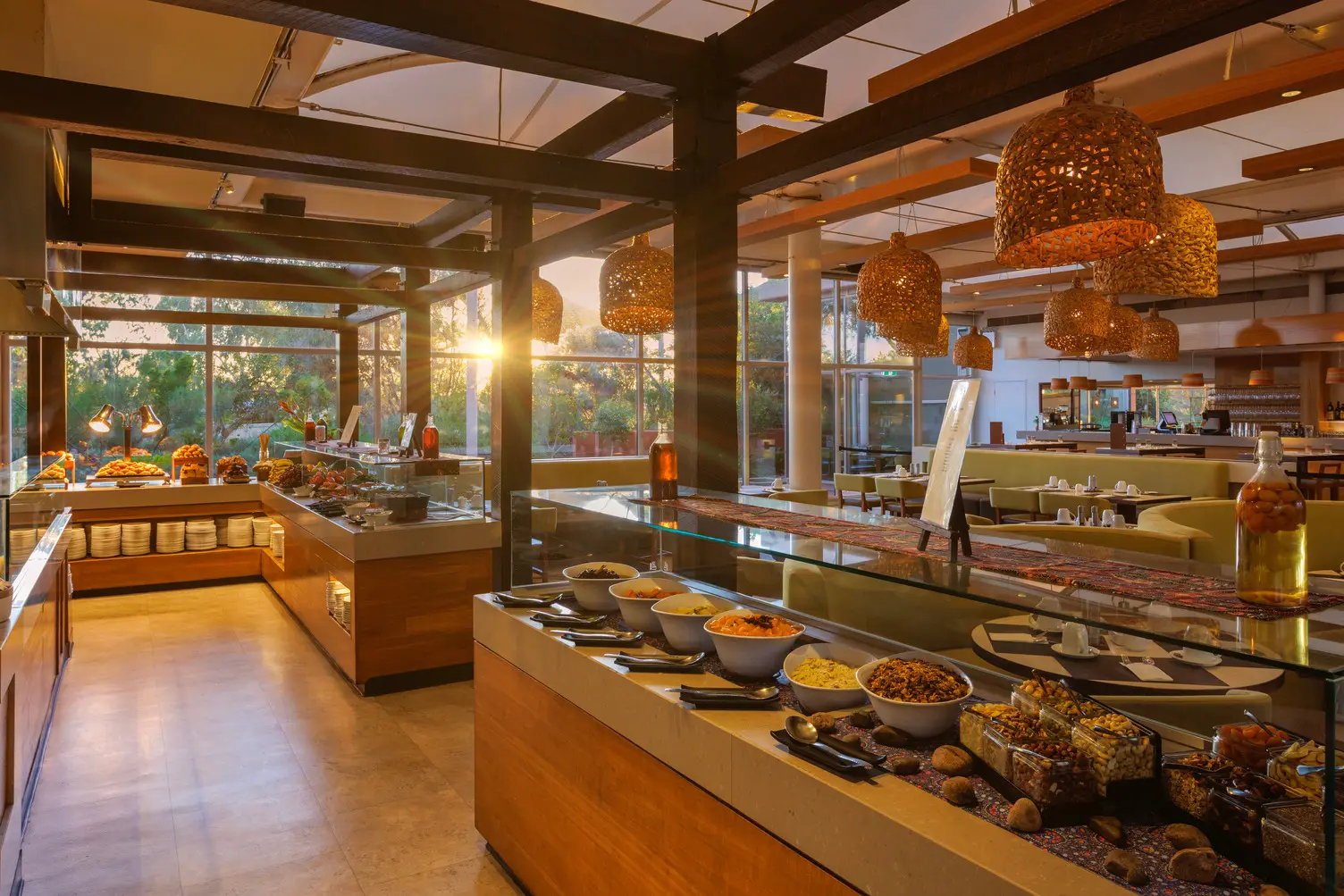 A widespan image of the selection of food at Ilkari Buffet Breakfast as the sun shines through the window during sunrise.