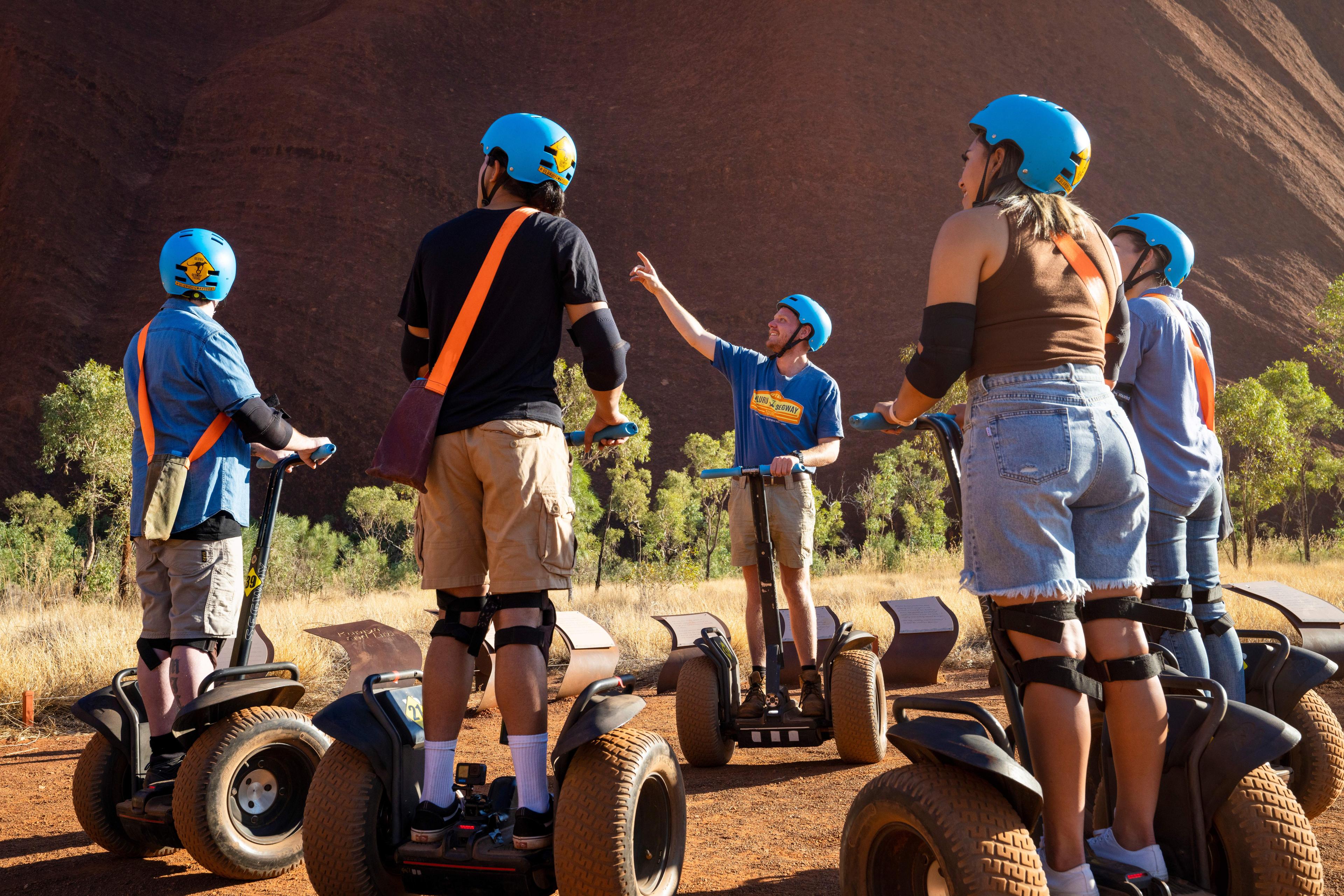 Group of guests on a guided Segway tour at the base of Uluru