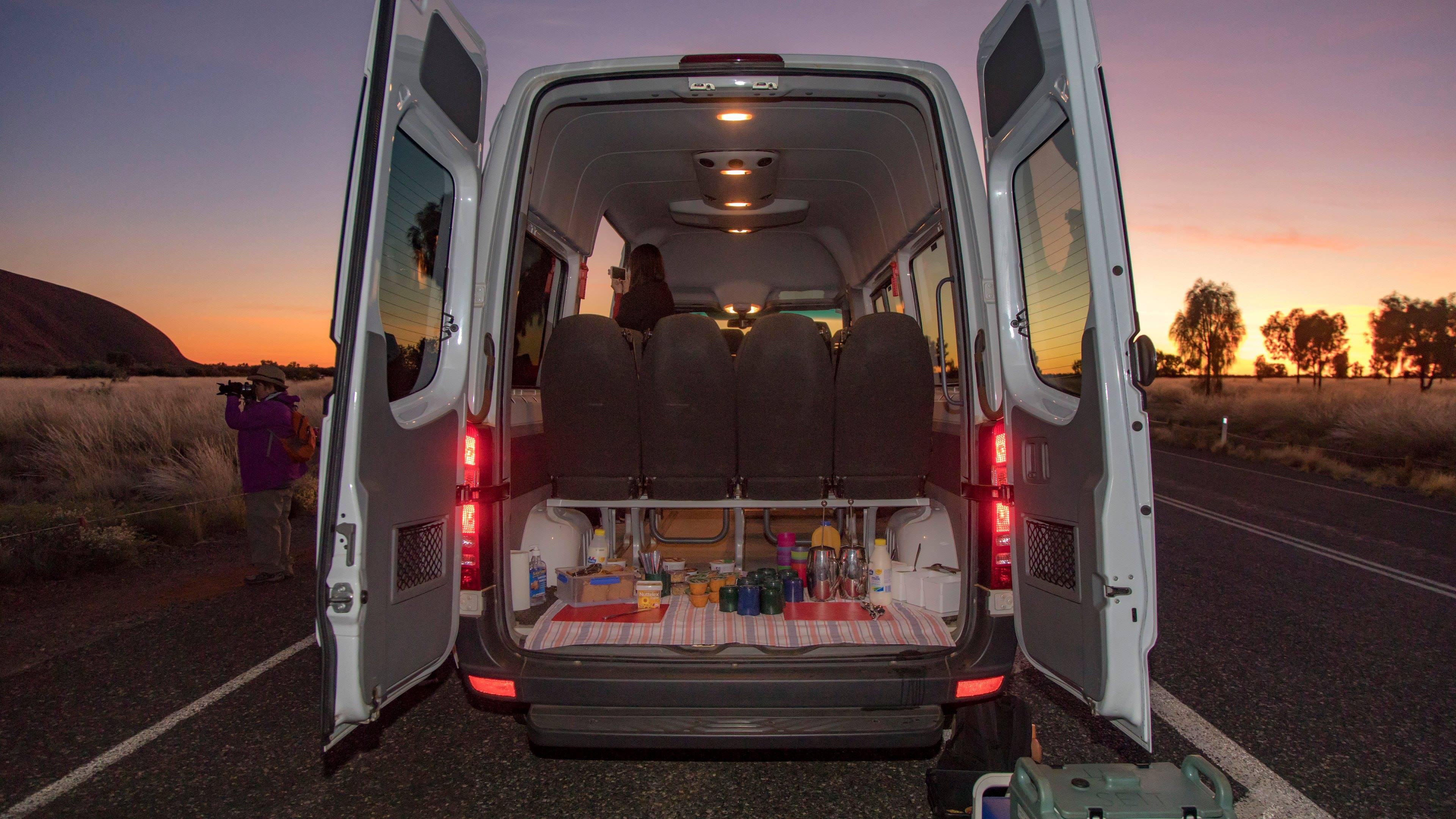 The back of an open van packed for a trek
