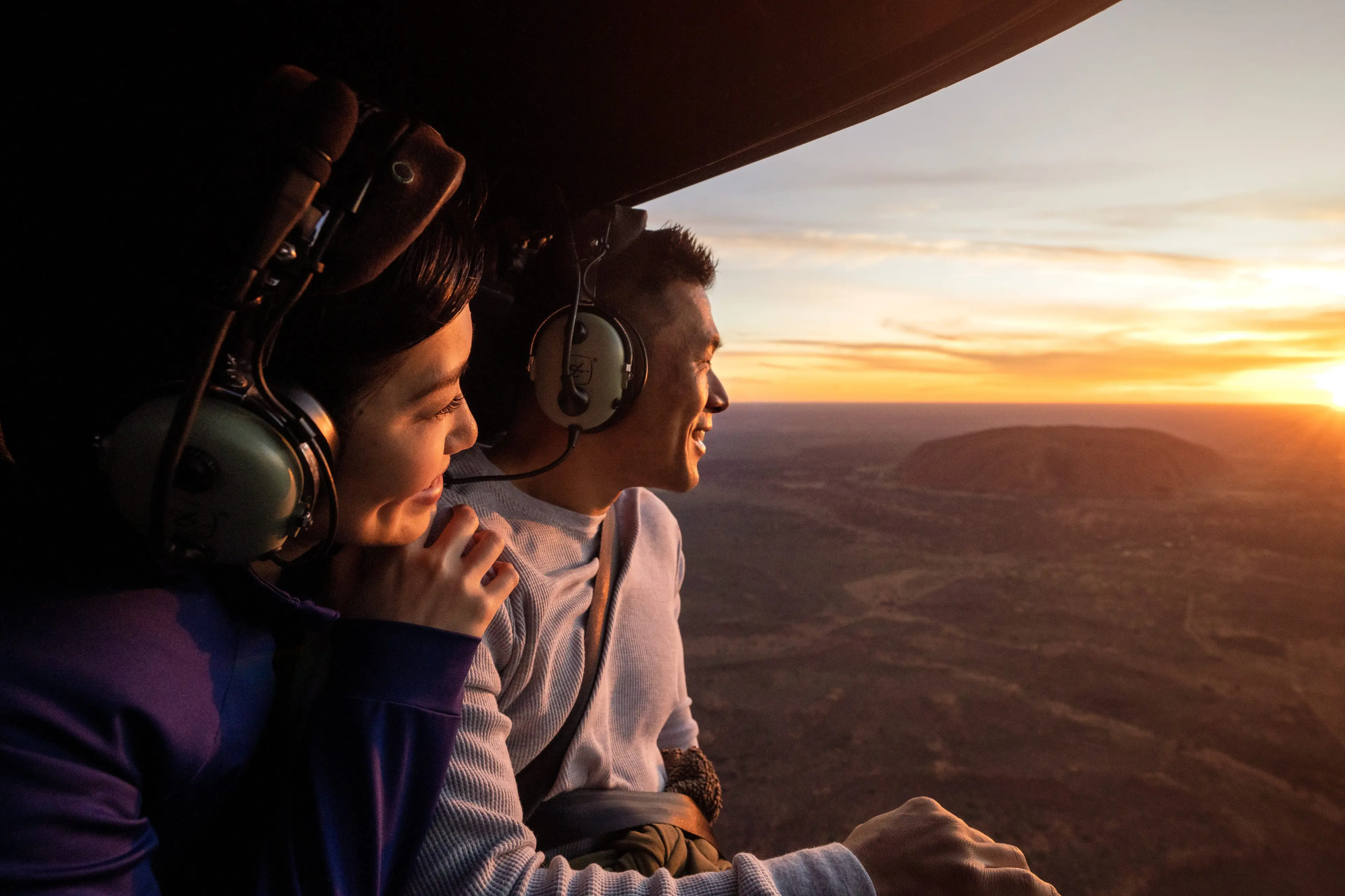 Couple in helicopter flying over Uluru