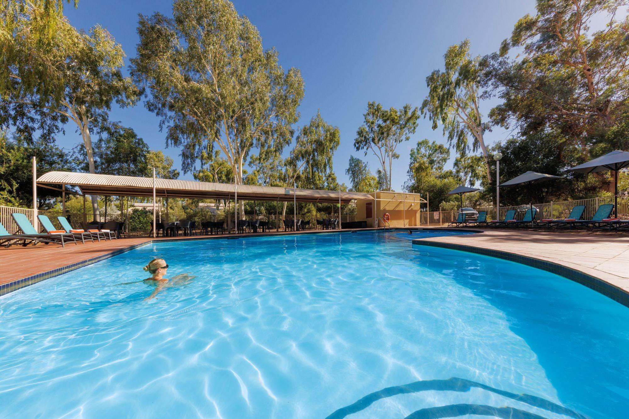 A woman in the swimming pool at the Outback Lodge, Ayers Rock Resort