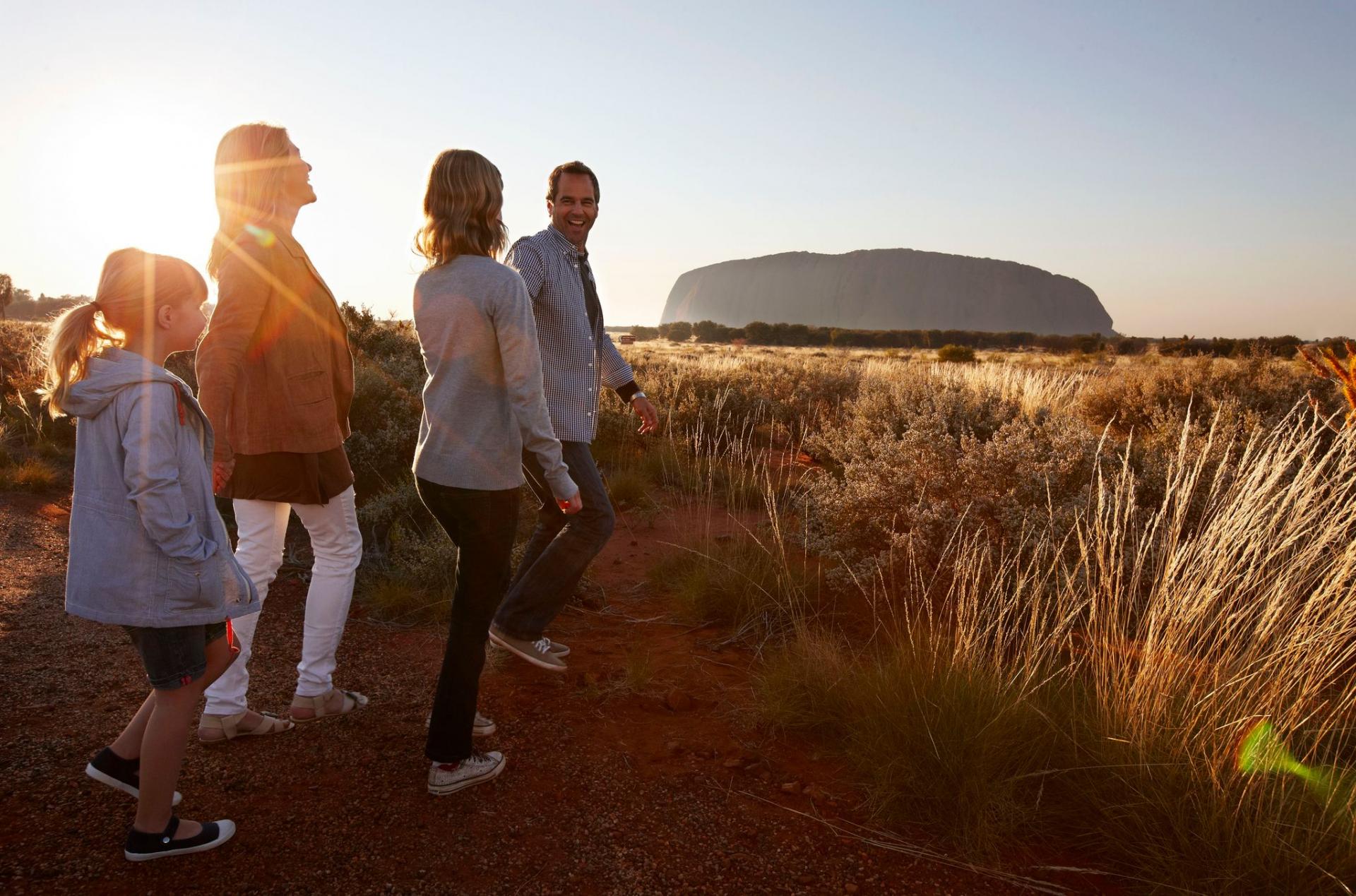 Family walking towards Uluru
