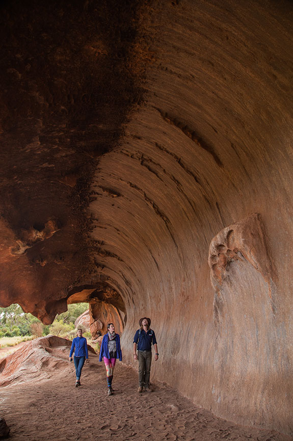 People hike near Uluru