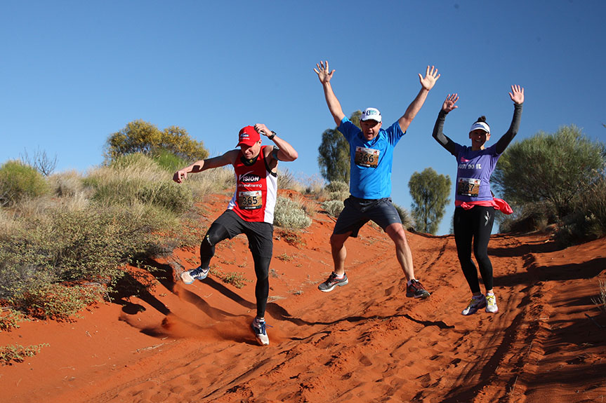 Runners jump excitedly in the Australian Outback Marathon