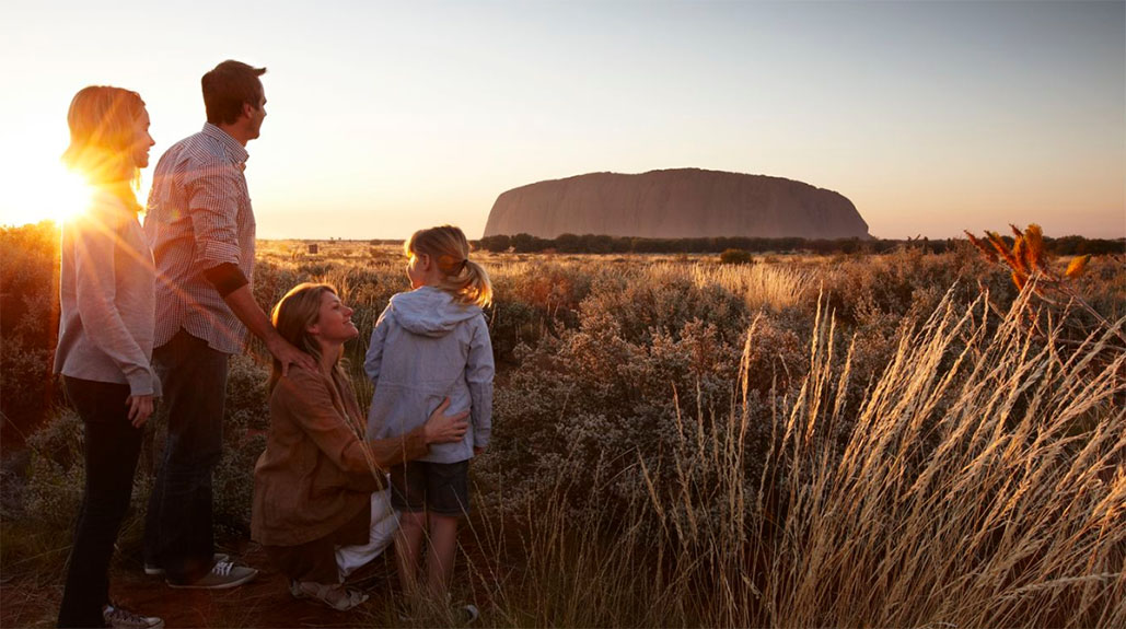 family in front of Ayers Rock