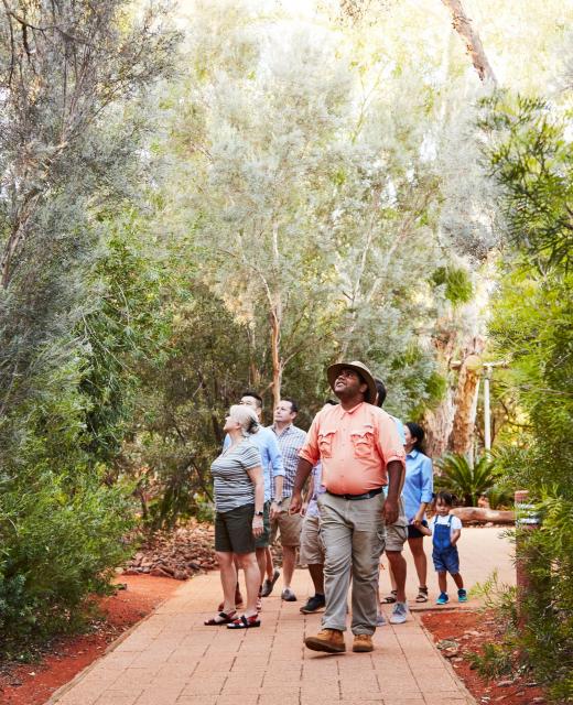 Group taking guided tour of gardens at Ayers Rock Resort