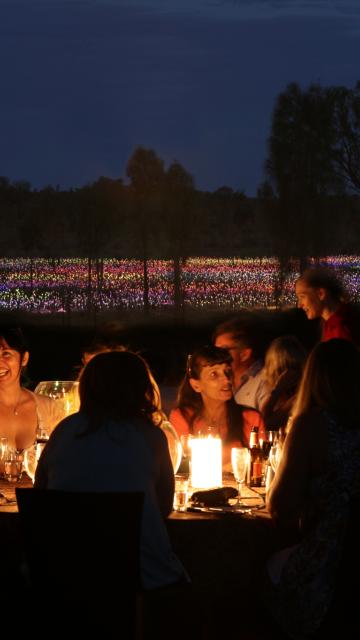 Dinner by candlelight in front of Field of Light at Ayers Rock