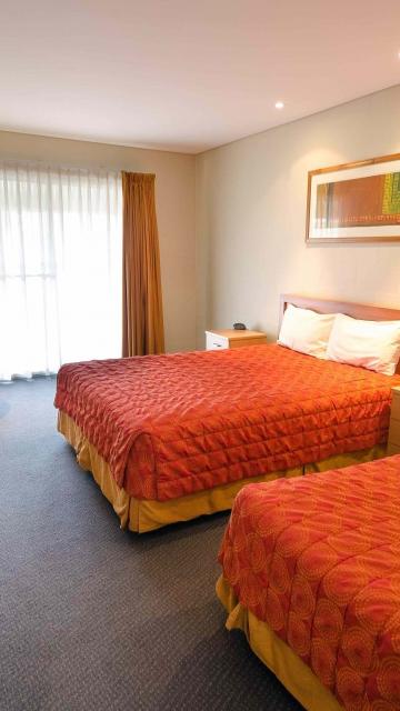 Hotel with 2 queen beds and orange bed spreads