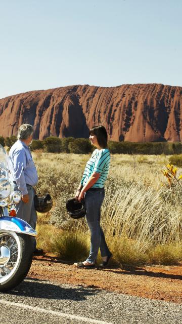 bikers looking out at Uluru