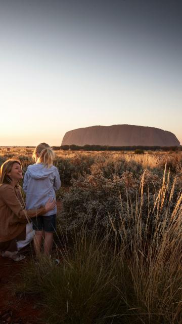 A family looking at Ayer's Rock at sunset | Uluru Australia | Uluru Rockies | Mossmangor Indigenous Tourism