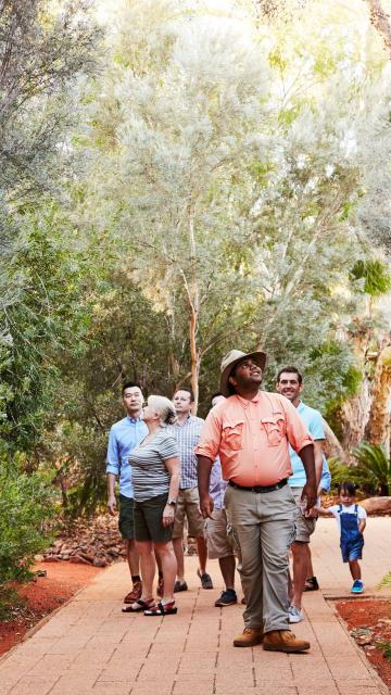 group with a tour guide on Garden walk at Ayers Rock Resort