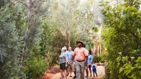 Group taking guided tour of gardens at Ayers Rock Resort