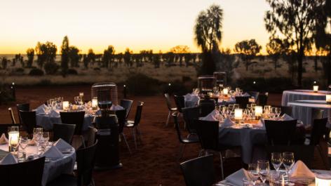 Dining tables set up outdoors at dusk