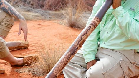 Didgeridoo being played by man in the outback