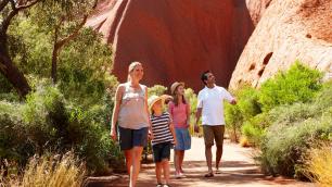 Family with 2 young children on base walk of Ayers Rock Uluru